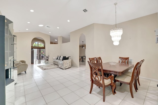 dining room with light tile patterned floors, a chandelier, and vaulted ceiling