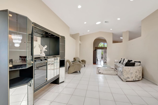 tiled living room featuring an inviting chandelier