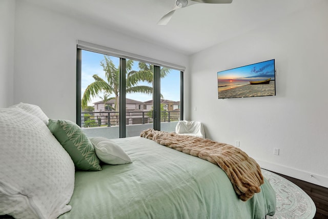 bedroom with hardwood / wood-style floors, ceiling fan, and multiple windows