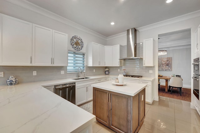 kitchen with white cabinetry, wall chimney range hood, sink, and stainless steel appliances