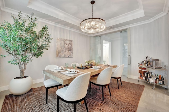 dining space featuring a chandelier, a raised ceiling, and crown molding