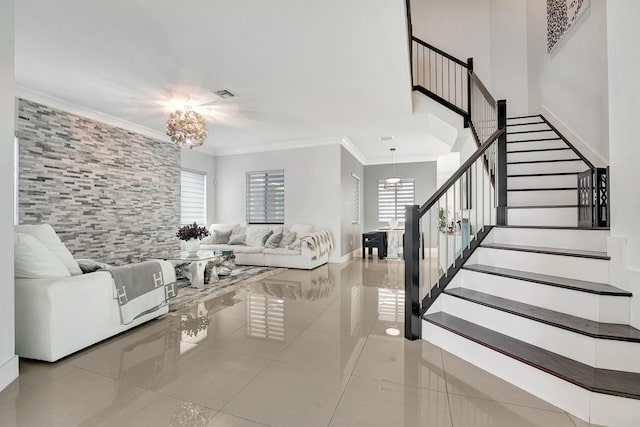 tiled living room featuring ornamental molding, plenty of natural light, and a notable chandelier