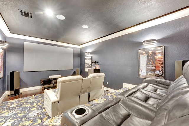 cinema with hardwood / wood-style flooring and a textured ceiling