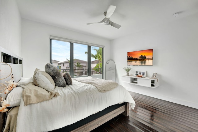 bedroom with dark hardwood / wood-style flooring and ceiling fan