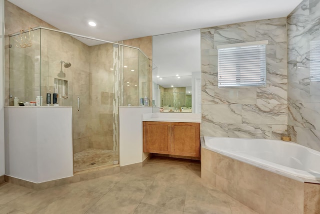 bathroom with tile walls, vanity, and plus walk in shower