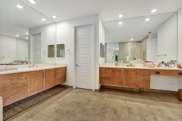 bathroom with tile patterned floors, vanity, and a shower with door