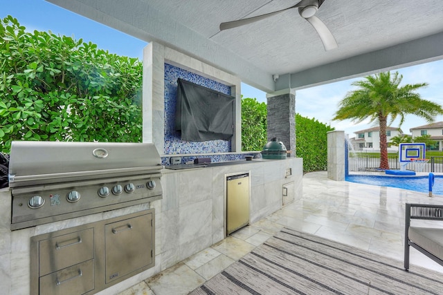 view of patio / terrace featuring a swimming pool, ceiling fan, an outdoor kitchen, and a grill