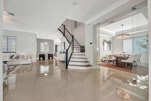 staircase featuring tile patterned flooring, an inviting chandelier, and crown molding