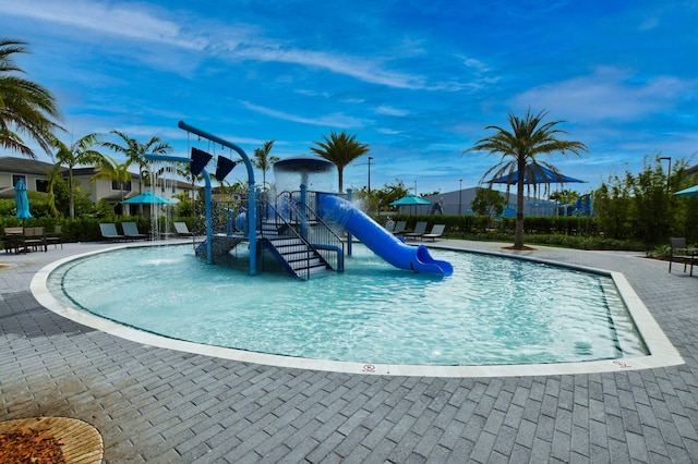 view of playground featuring pool water feature, a community pool, and a patio area