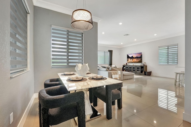 dining room with ornamental molding and light tile patterned flooring