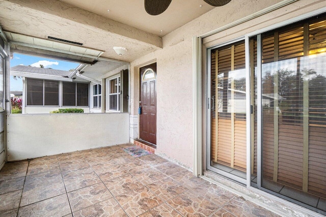 view of exterior entry featuring ceiling fan