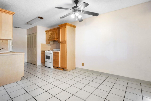 kitchen with premium range hood, a textured ceiling, ceiling fan, light tile patterned floors, and electric range