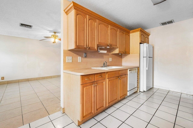 kitchen with ceiling fan, sink, a textured ceiling, white appliances, and light tile patterned flooring