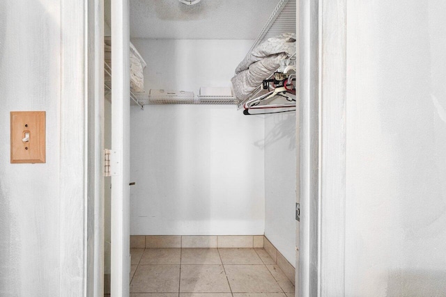 spacious closet featuring light tile patterned floors