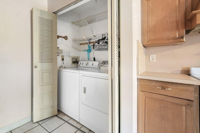 laundry room with light tile patterned flooring and washing machine and clothes dryer