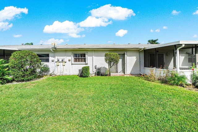 rear view of house featuring a yard