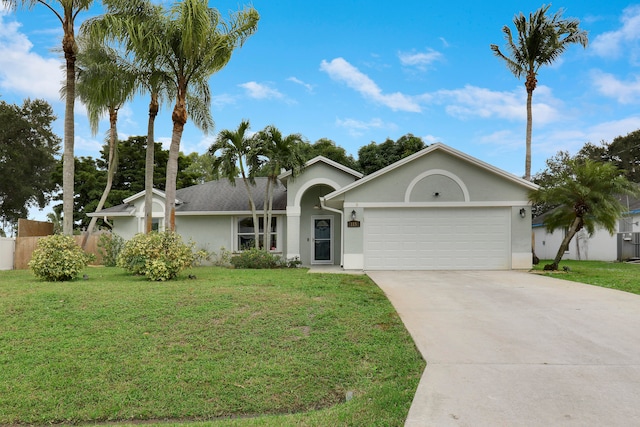 ranch-style home featuring a garage and a front lawn