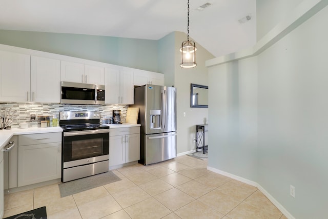 kitchen featuring white cabinets, hanging light fixtures, light tile patterned floors, backsplash, and appliances with stainless steel finishes