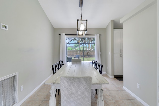 tiled dining room featuring a notable chandelier