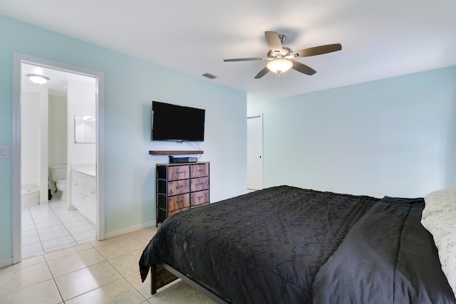 tiled bedroom with ceiling fan and connected bathroom