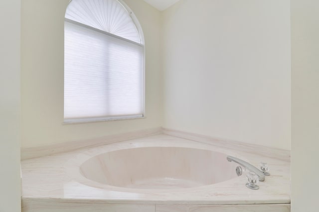 bathroom with tiled tub