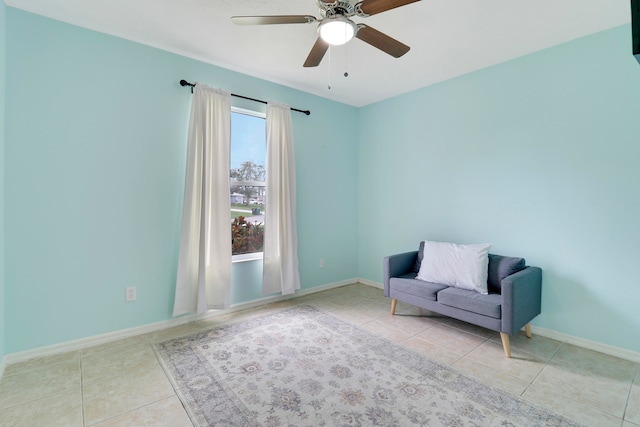 living area featuring ceiling fan and light tile patterned floors