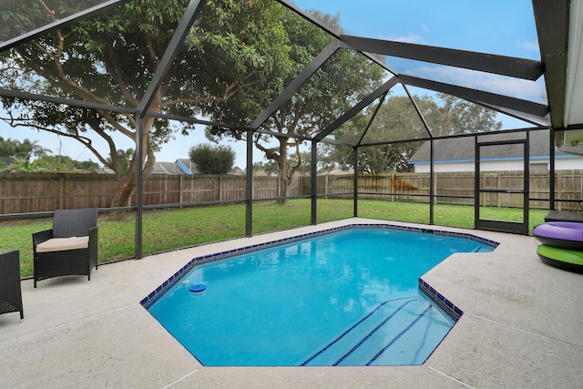 view of swimming pool featuring glass enclosure, a yard, and a patio