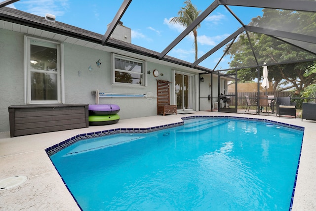 view of swimming pool featuring a lanai and a patio