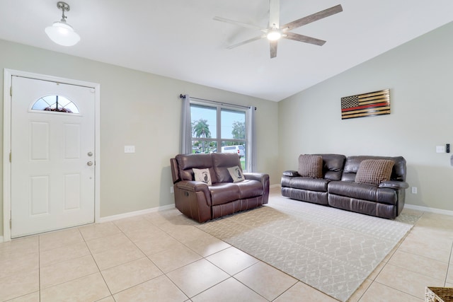 living room with light tile patterned floors, ceiling fan, and vaulted ceiling