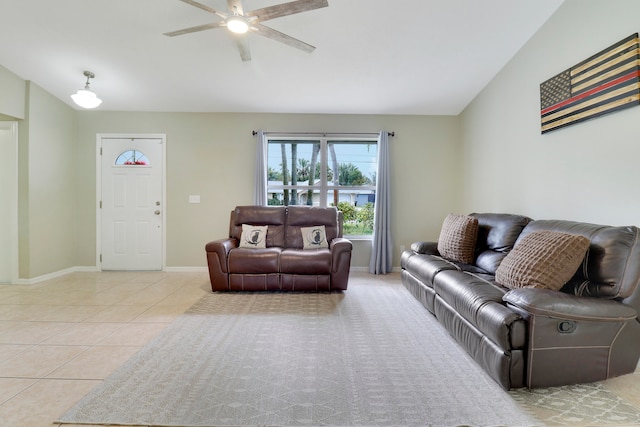 living room with lofted ceiling, ceiling fan, and light tile patterned flooring