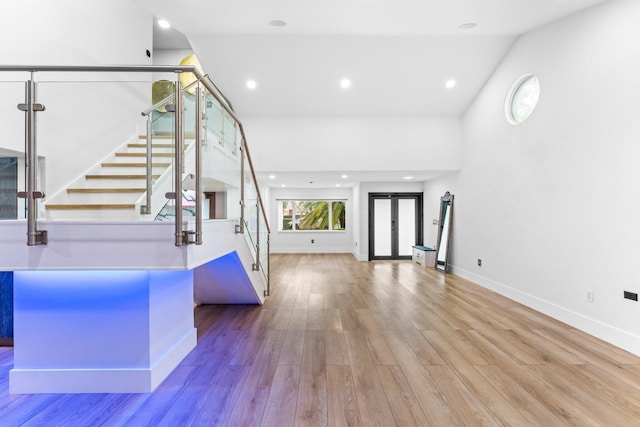 entryway with stairs, baseboards, wood finished floors, and recessed lighting