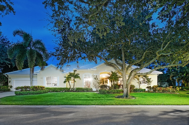 view of front facade featuring a front yard and a garage