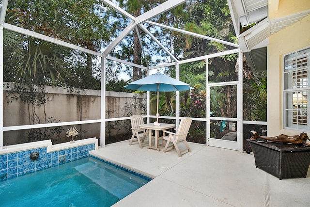 view of pool featuring glass enclosure, fence, a patio area, and a fenced in pool