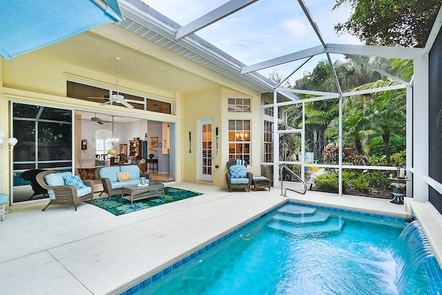 pool with a ceiling fan, a lanai, a patio area, and outdoor lounge area