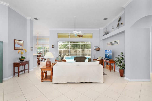 living room with crown molding, light tile patterned floors, and visible vents