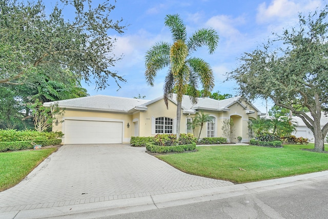 single story home with a front yard and a garage