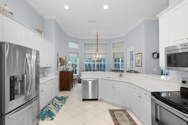 kitchen featuring a sink, appliances with stainless steel finishes, white cabinets, crown molding, and light tile patterned floors