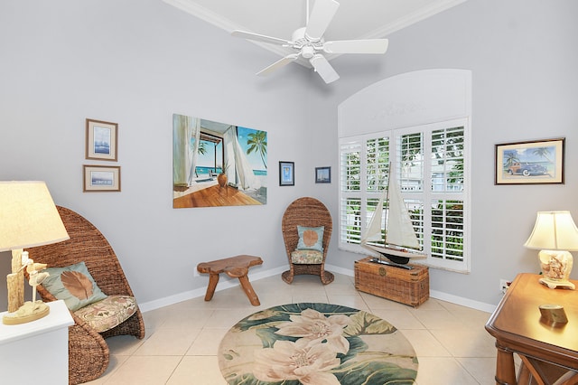 sitting room featuring tile patterned flooring, a healthy amount of sunlight, and crown molding