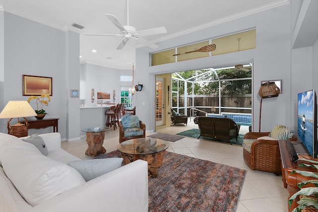 living room featuring visible vents, a ceiling fan, crown molding, a sunroom, and tile patterned flooring