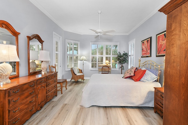 bedroom with light wood-style flooring, ceiling fan, baseboards, and ornamental molding