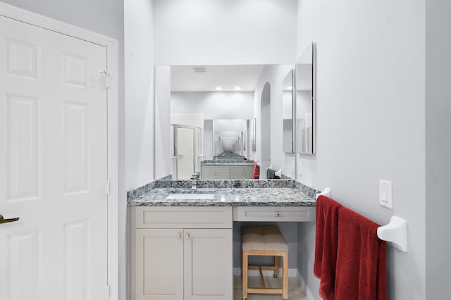 full bath with vanity, a shower stall, and visible vents