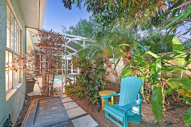 view of patio with an outdoor pool, glass enclosure, and a fenced backyard