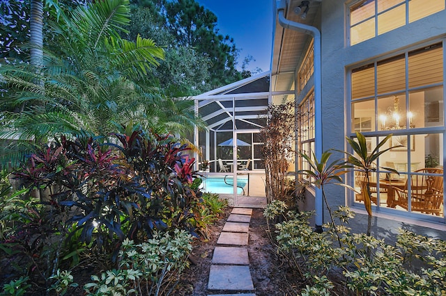 exterior space with glass enclosure and an outdoor pool