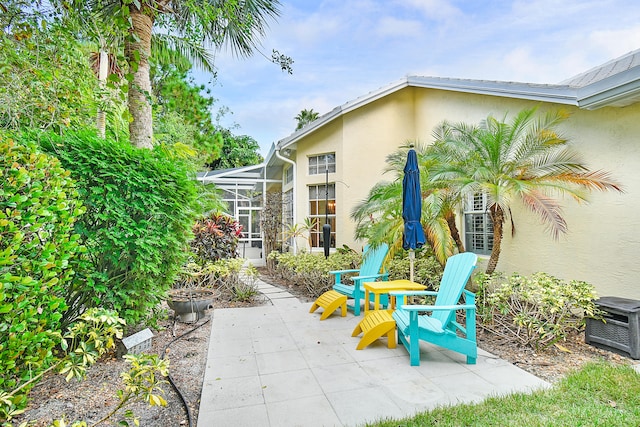 view of patio featuring a lanai