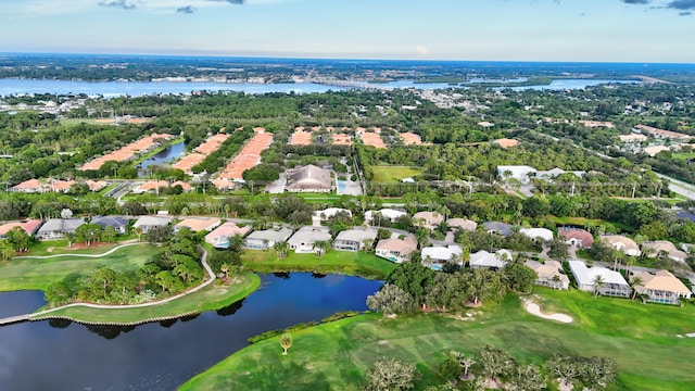 bird's eye view with golf course view, a water view, and a residential view