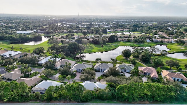 drone / aerial view with a residential view, a water view, and view of golf course