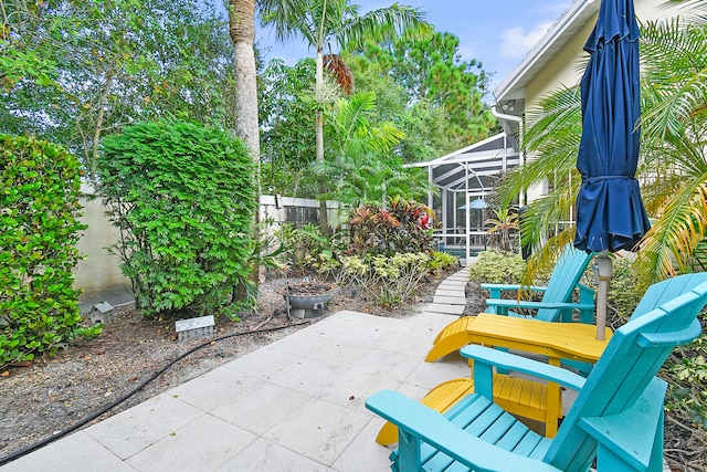 view of patio featuring a lanai and fence