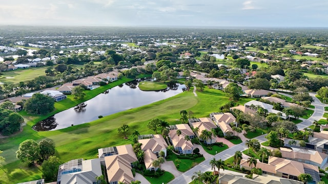 birds eye view of property with a residential view, a water view, and view of golf course