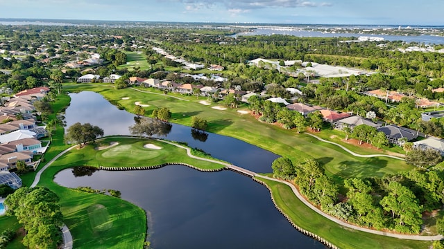 aerial view with a residential view, a water view, and view of golf course