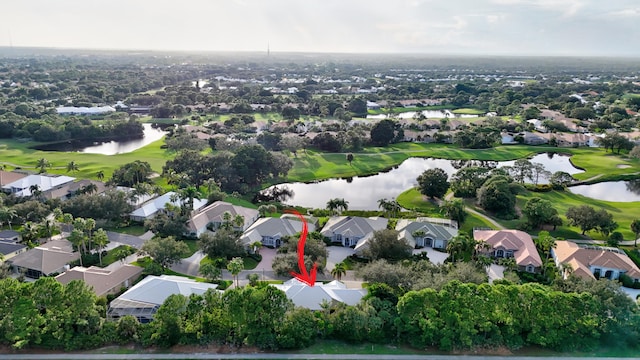 drone / aerial view with a residential view, a water view, and golf course view